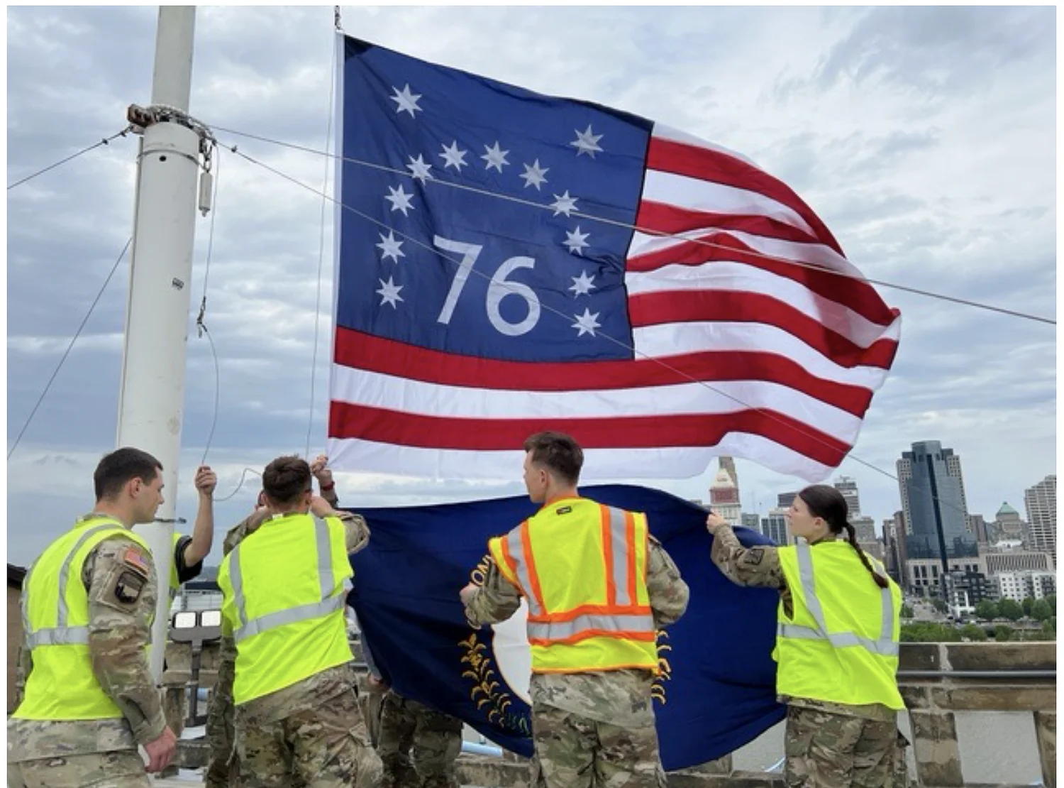 University of Cincinnati ROTC members replace flags atop Roebling Bridge