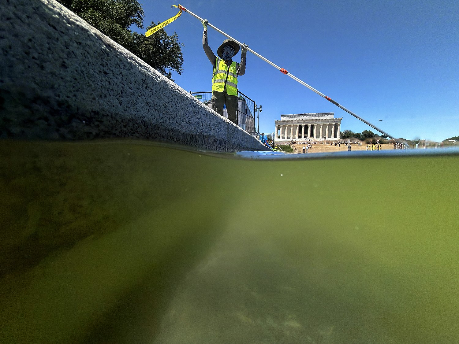Reflecting pool in D.C. was supposed to be blue. Now it’s green, and some are seeing red