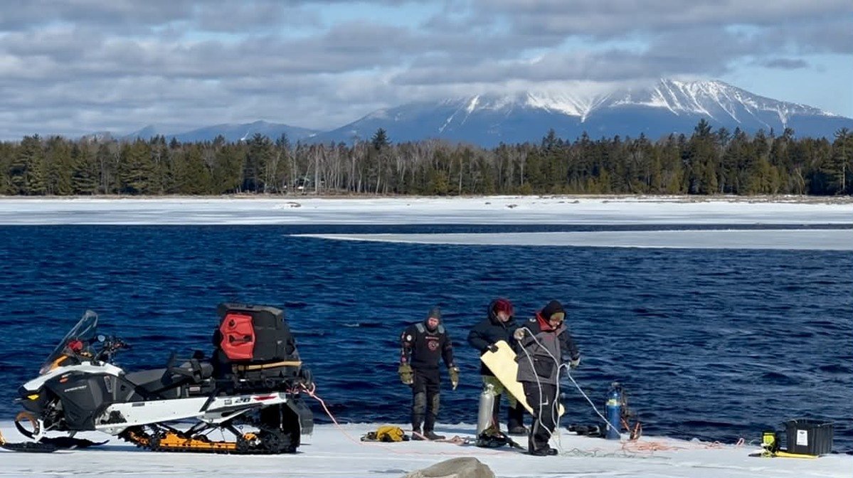Drone video shows diver recovering snowmobile that fell through lake ice