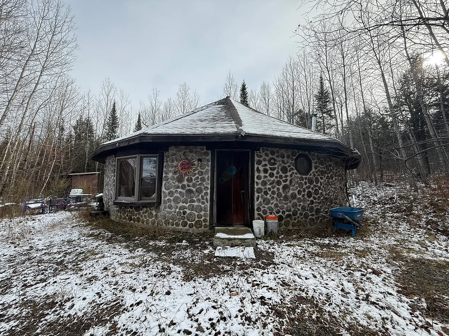 A quaint wood and concrete yurt is for sale in rural Maine