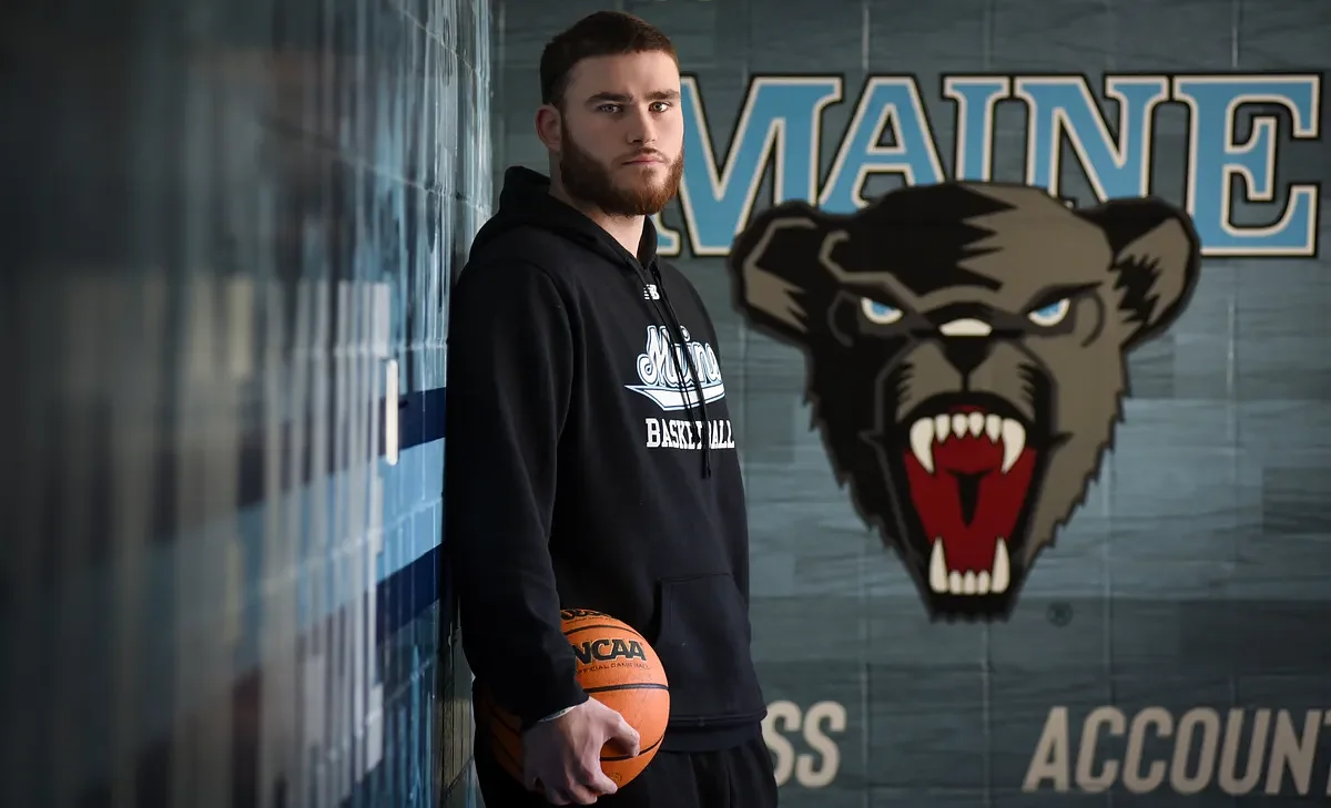A cardiac condition keeps him off the court. But he’s still at the heart of UMaine basketball.