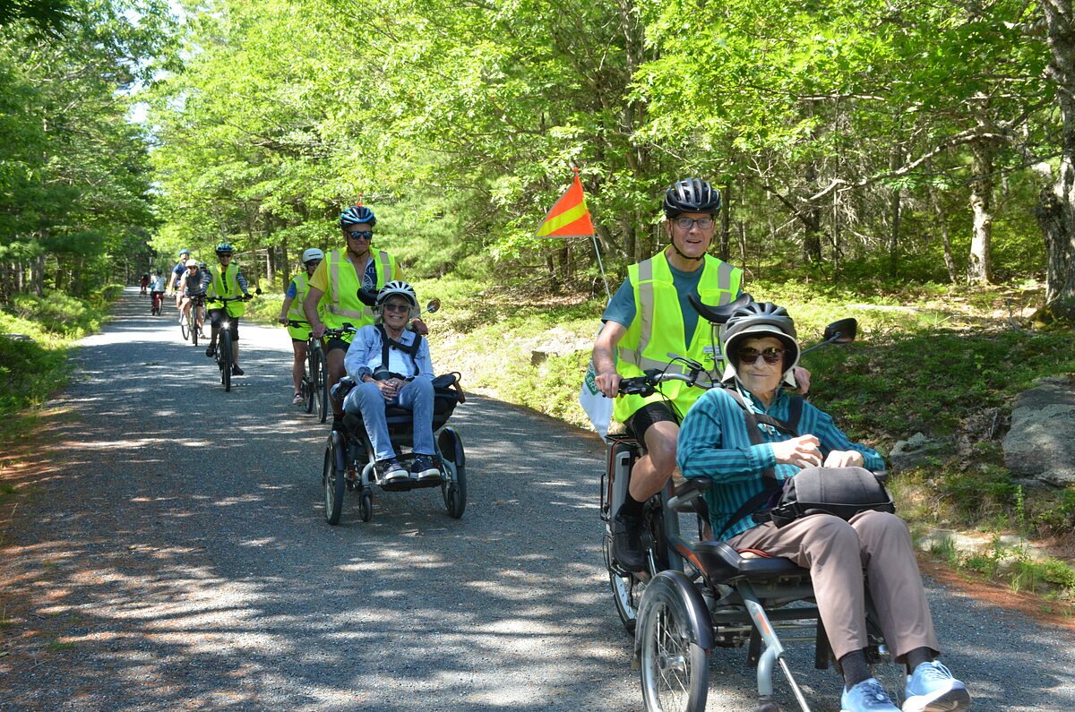Volunteers pedal people with disabilities along Acadia’s carriage roads