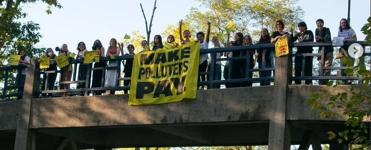 Smith College students drop a banner in support of Climate Superfund bill