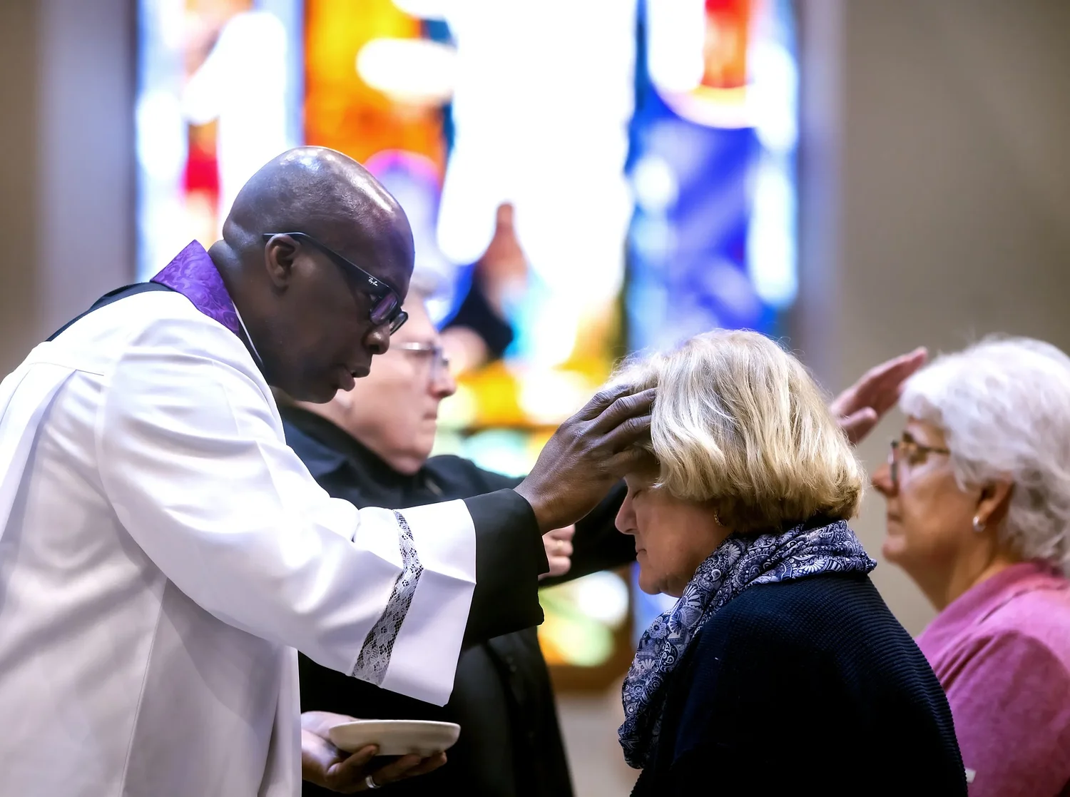 Believers receive ashes at St. Paul's Church in Concord