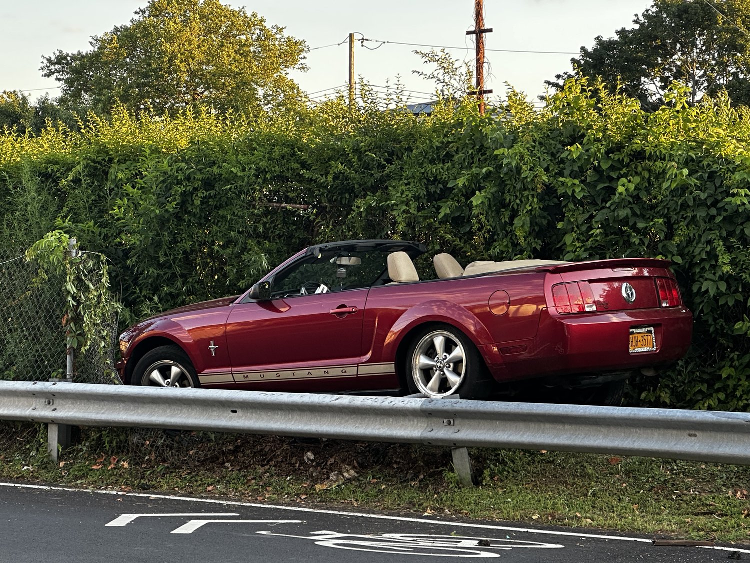 Driver loses control, Mustang ends up perched on guardrail in Staten Island crash