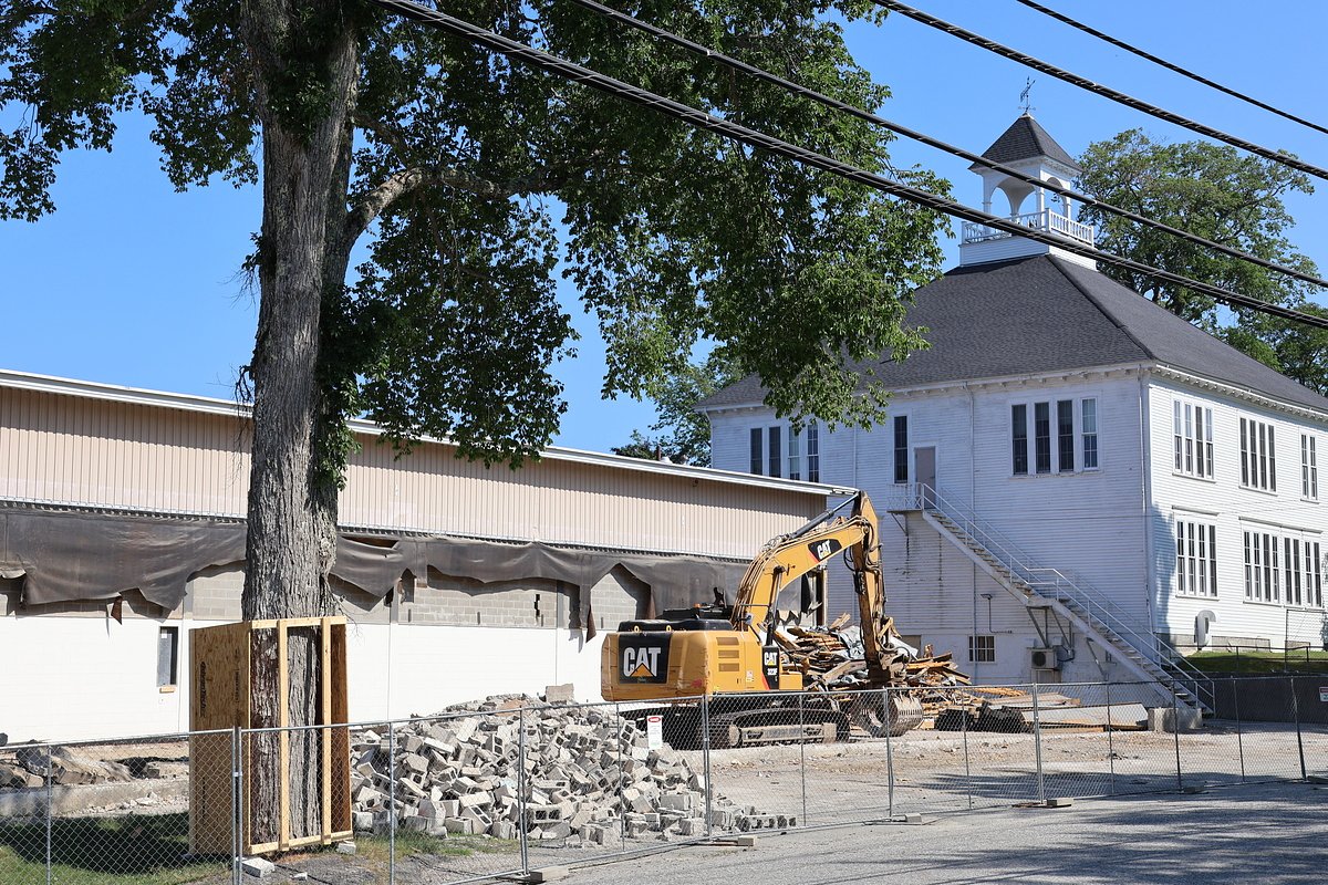 A Blue Hill high school is building a new main entrance despite making staff cuts