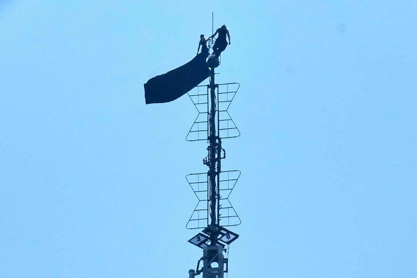 Masked duo scales Empire State Building antenna to unveil message
