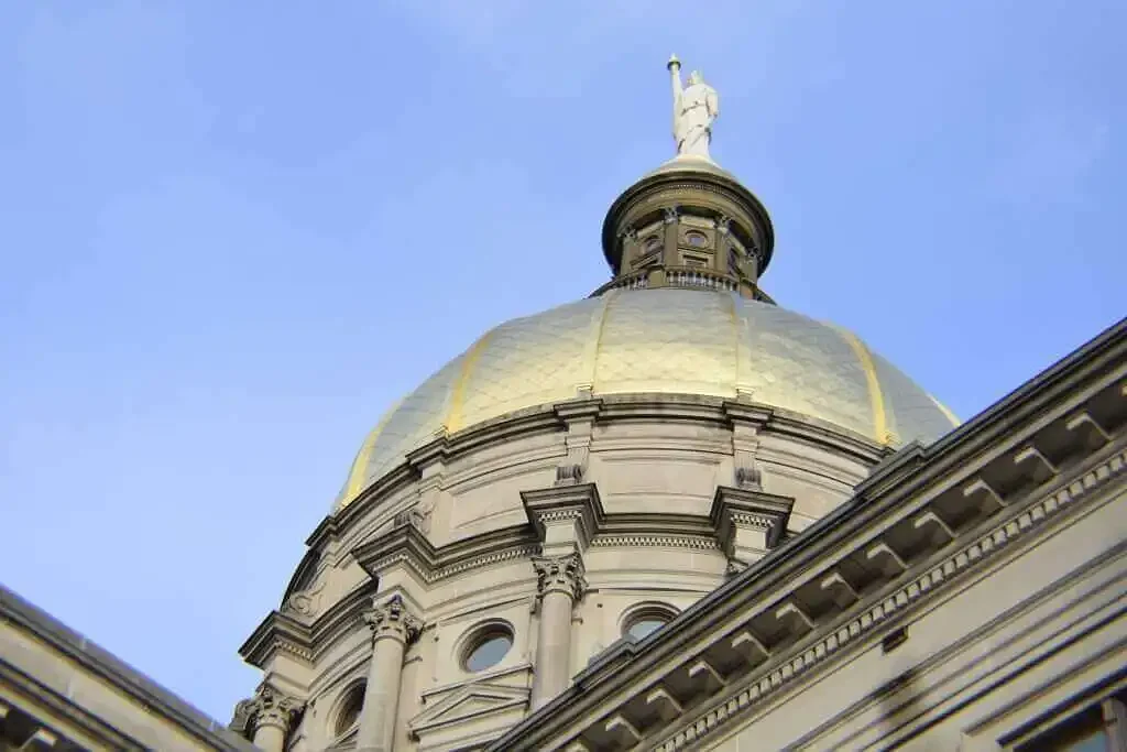 Kemp signs elections bill, locking in QR code voting machines for November
