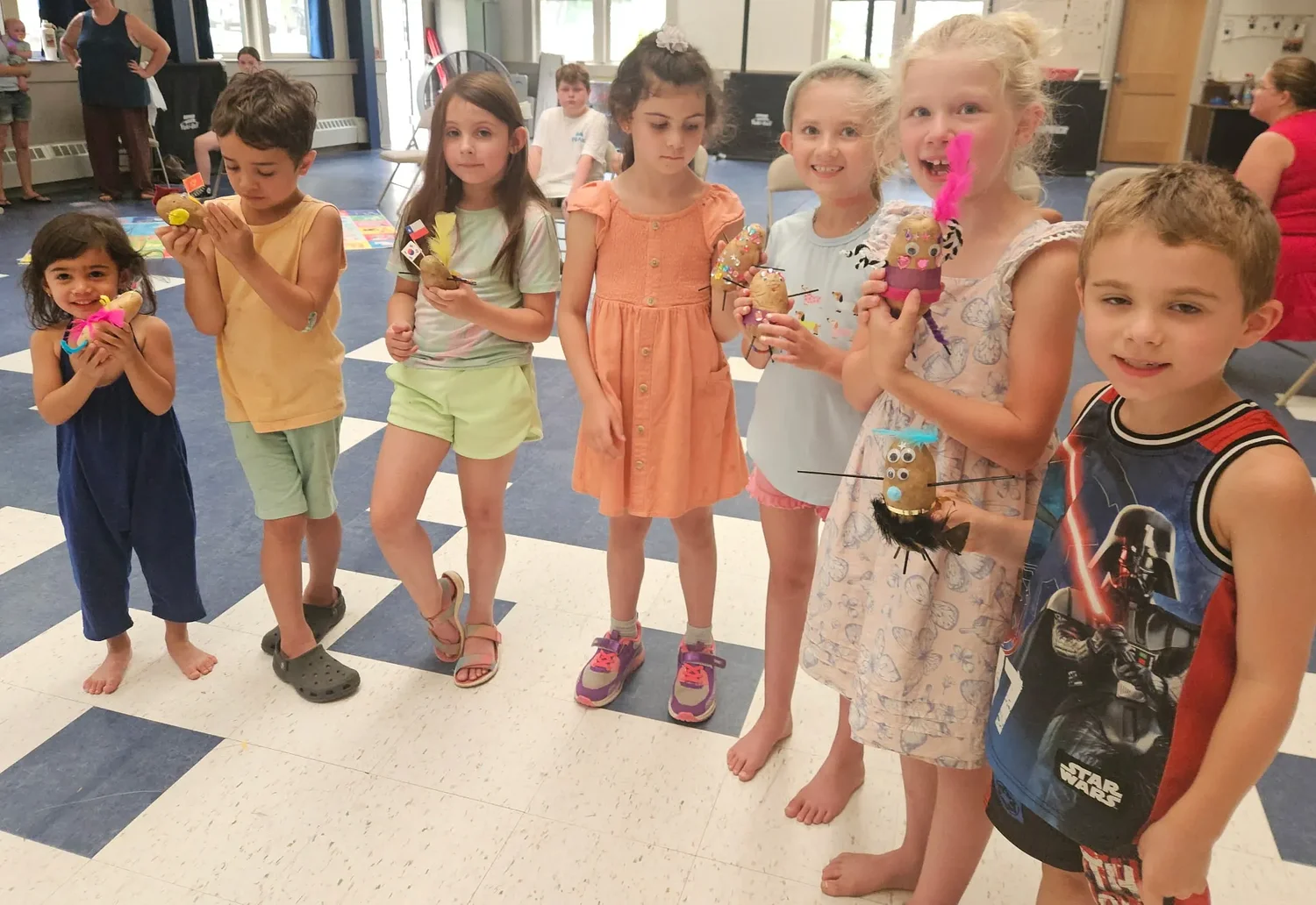 Mason students create potato people during summer reading visit