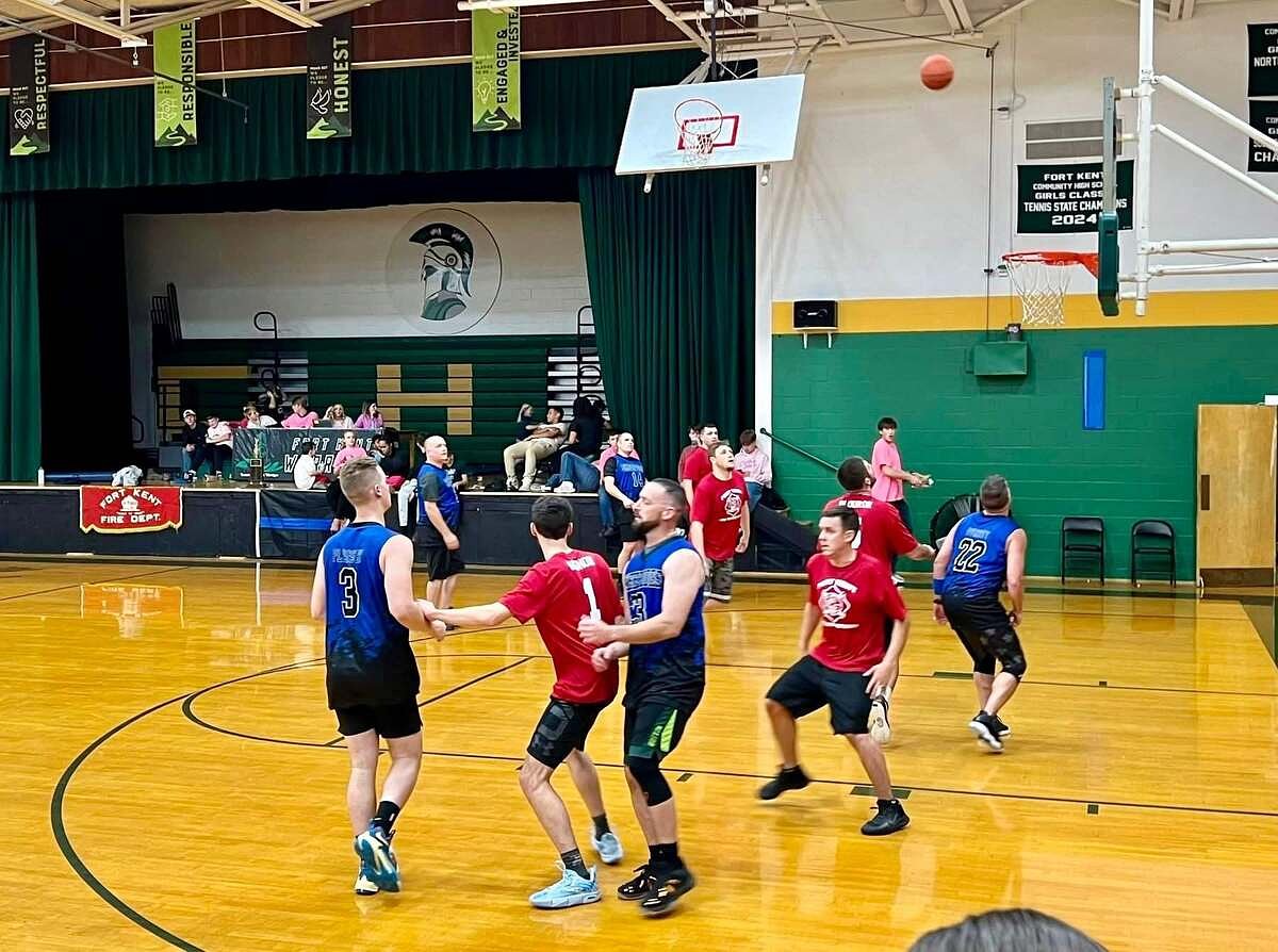 Fort Kent firefighters and police stage a battle on the court to help families