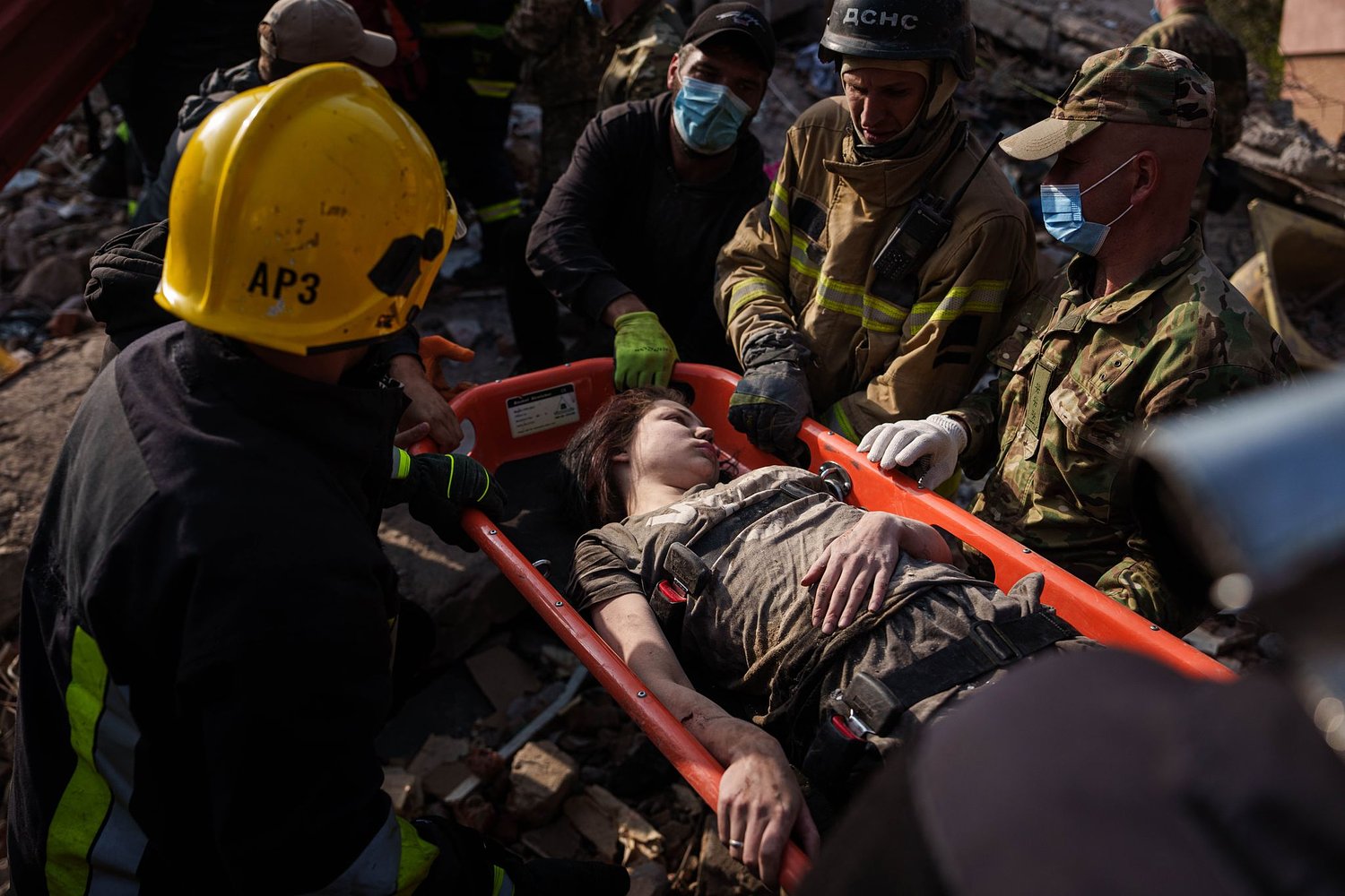 People clear the rubble of a residential building destroyed in a Russian missile strike, in photos