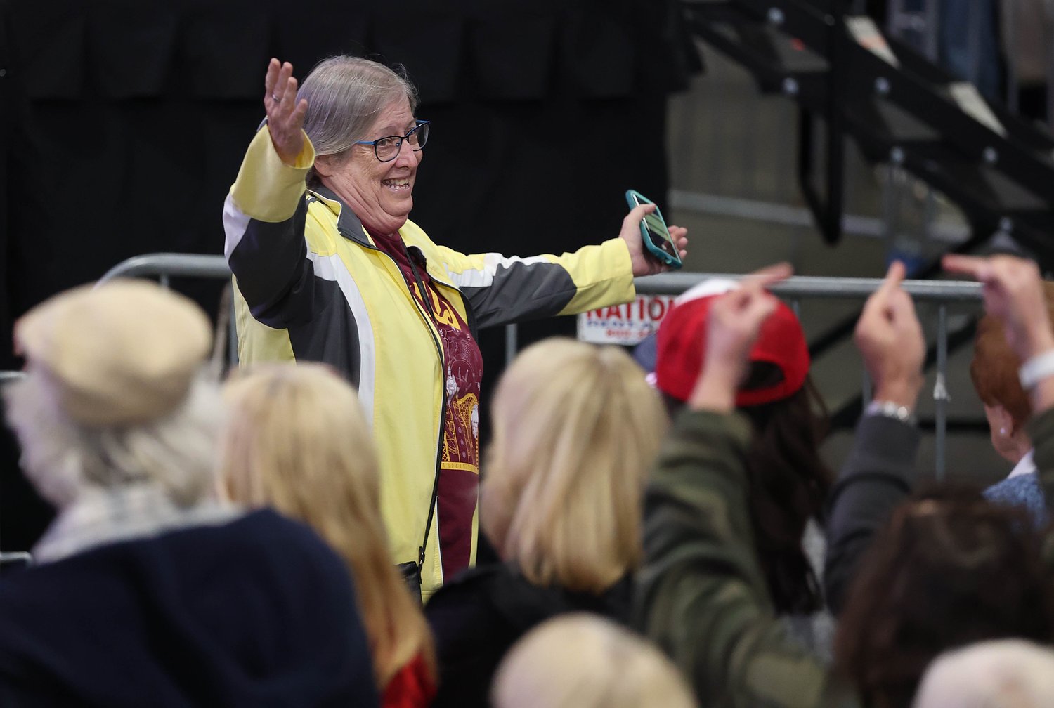 Woman in yellow jacket fires middle fingers as she’s tossed from Trump’s Syracuse rally (video)
