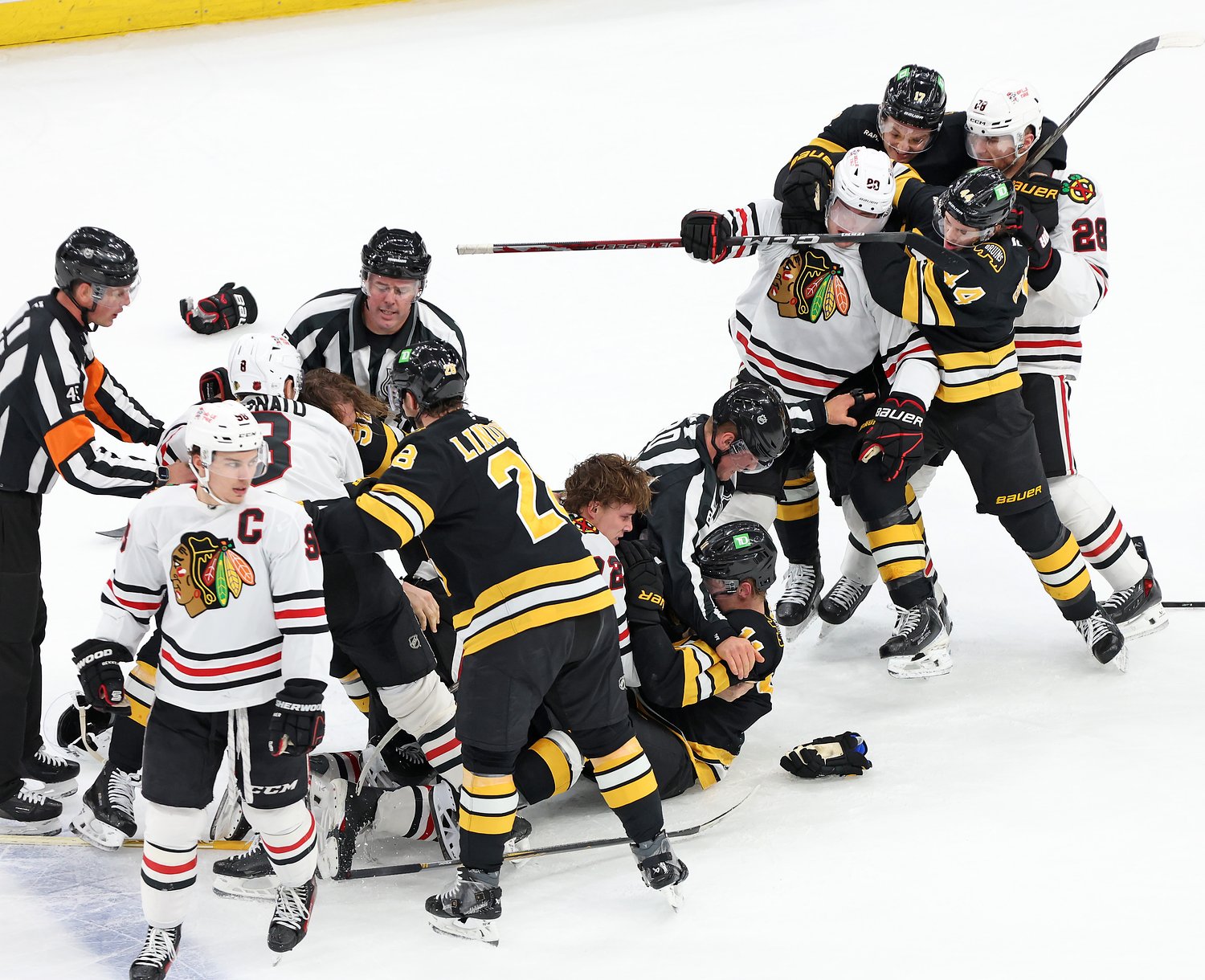 Chaos erupts after Blackhawks defenseman goes after Bruins forward who does not have NHL fight