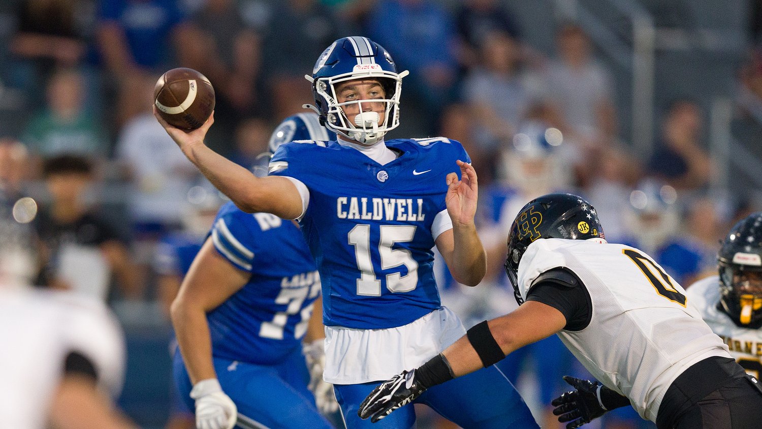 Junior QB throws 5 TDs as unbeaten football team rolls to victory