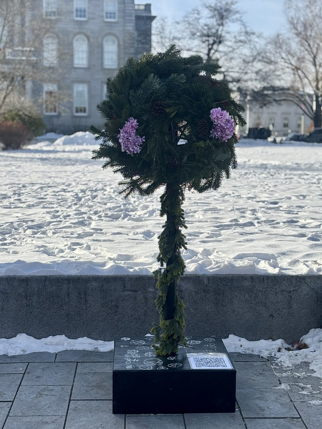 Satanic Temple installs holiday display in front of New Hampshire State House