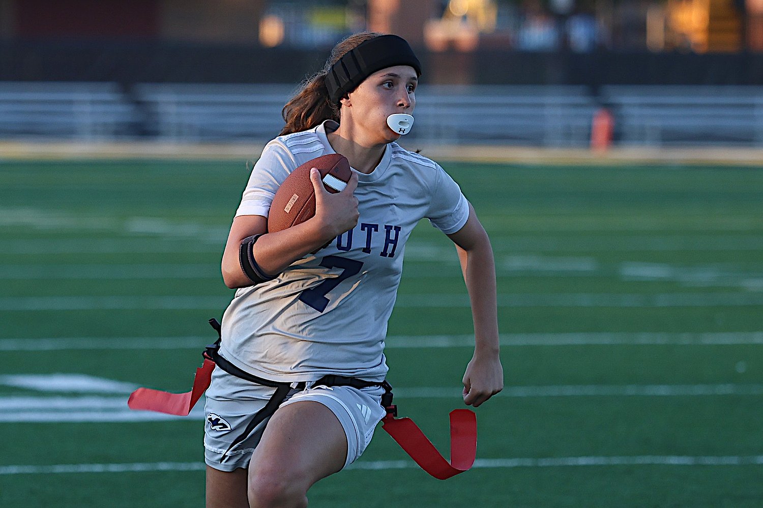 Brooke McDonald uses her arm and legs to lead Plainfield South flag fooball past Joliet West