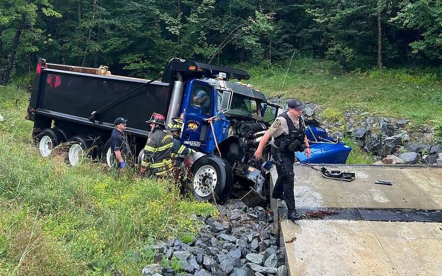 Maine dump truck crashes into concrete culvert while passing a tractor-trailer