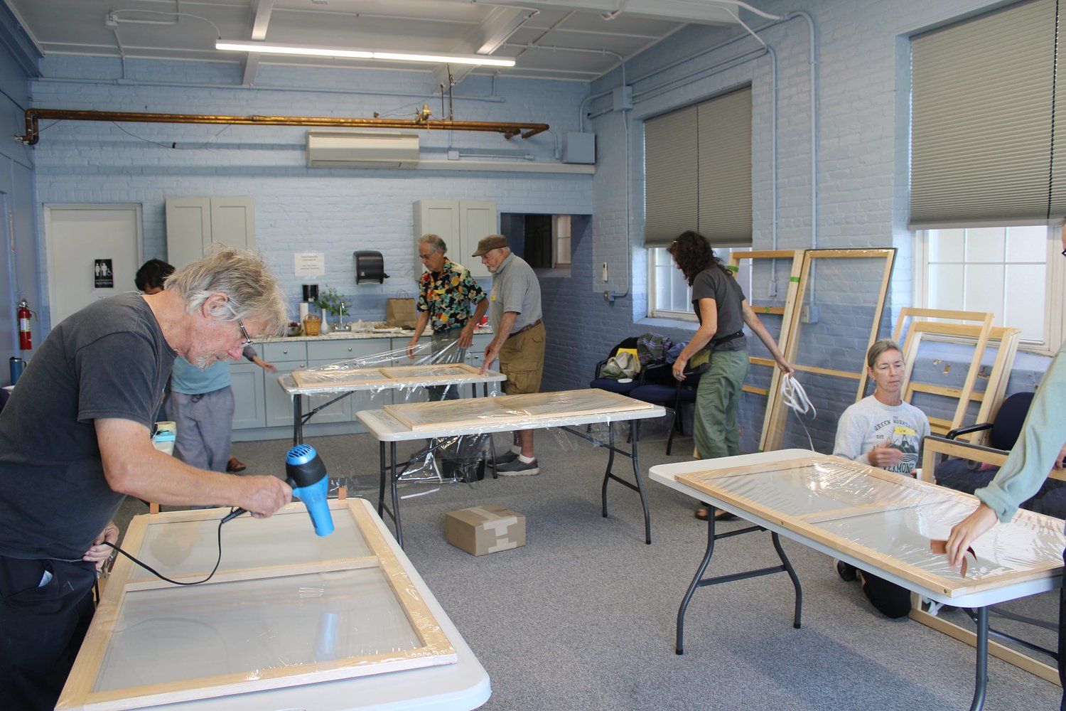 A warming project in more ways than one: Community builds in Montague craft window inserts ahead of winter