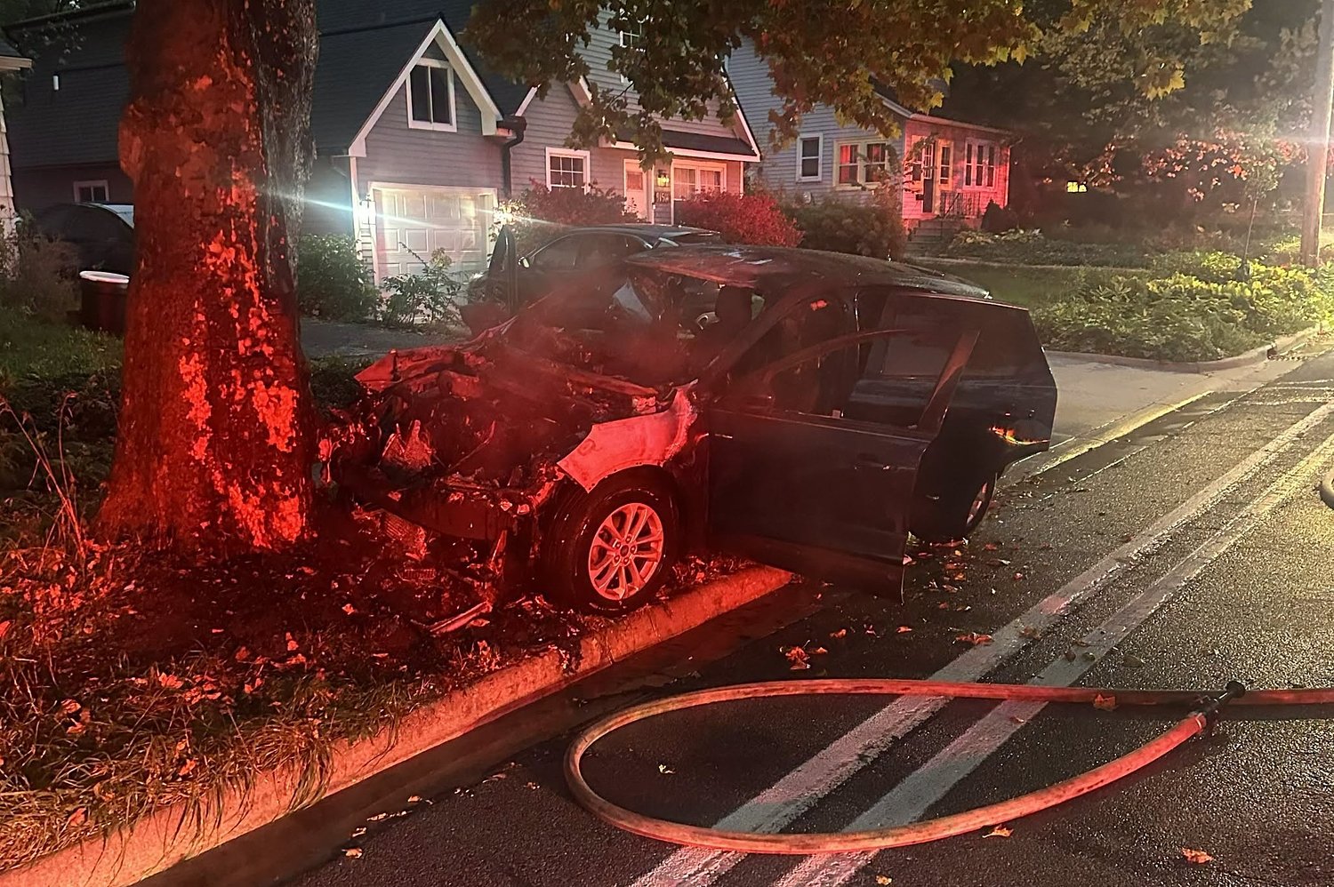 Parking error sends burning car rolling into Ann Arbor neighborhood tree