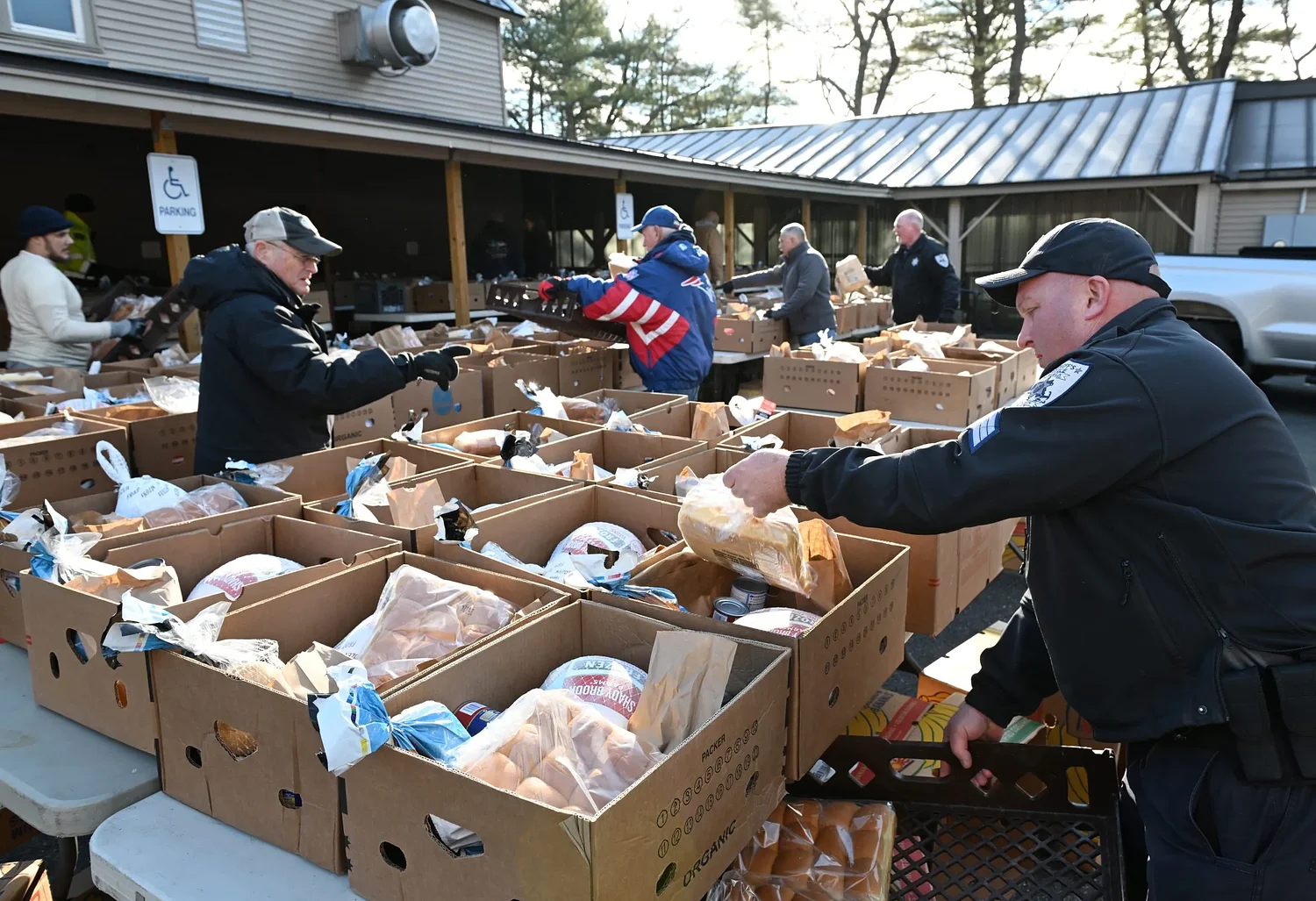 Volunteers fill boxes to the brim with Thanksgiving staples for locals in need