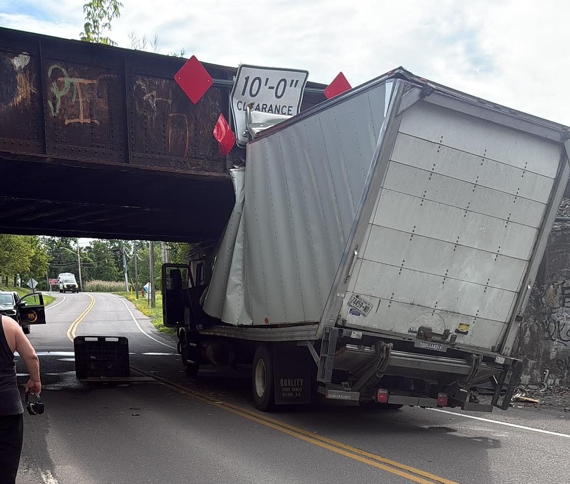 Box truck crumples when it hits railroad bridge in DeWitt