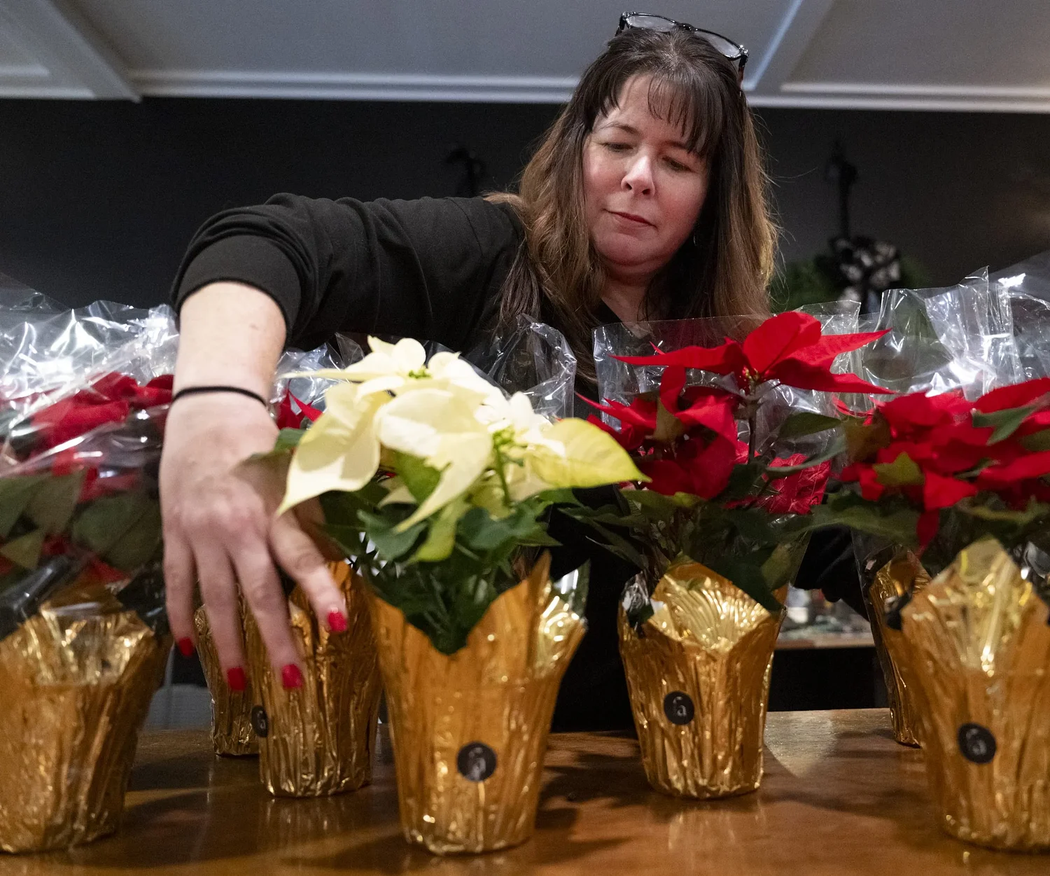 Floral Affairs spreads holiday cheer with 795 poinsettias for seniors