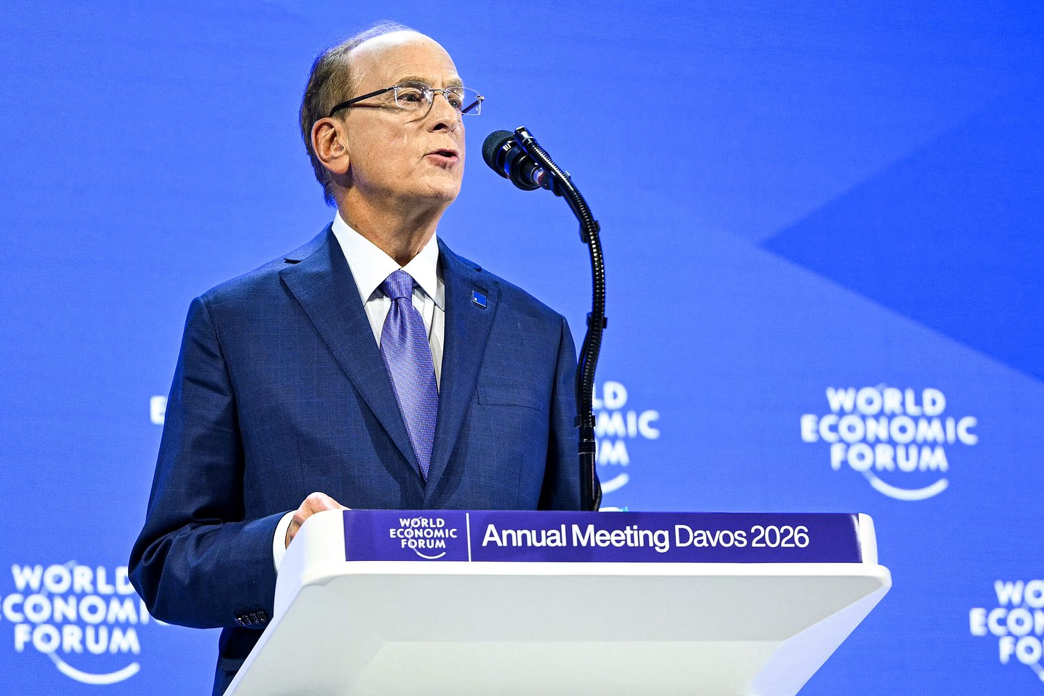 Davos fashion statement: Robert Kraft's blue square pins on elites' lapels