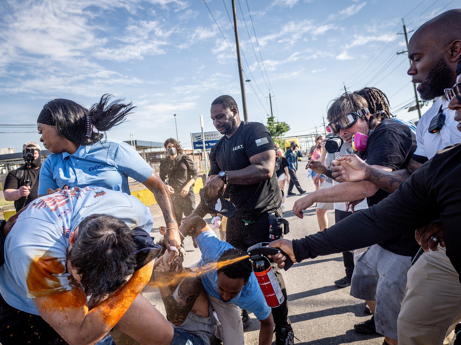 Tensions rise as protesters block vehicles at Delaney Hall, with tear gas deployed and cars damaged