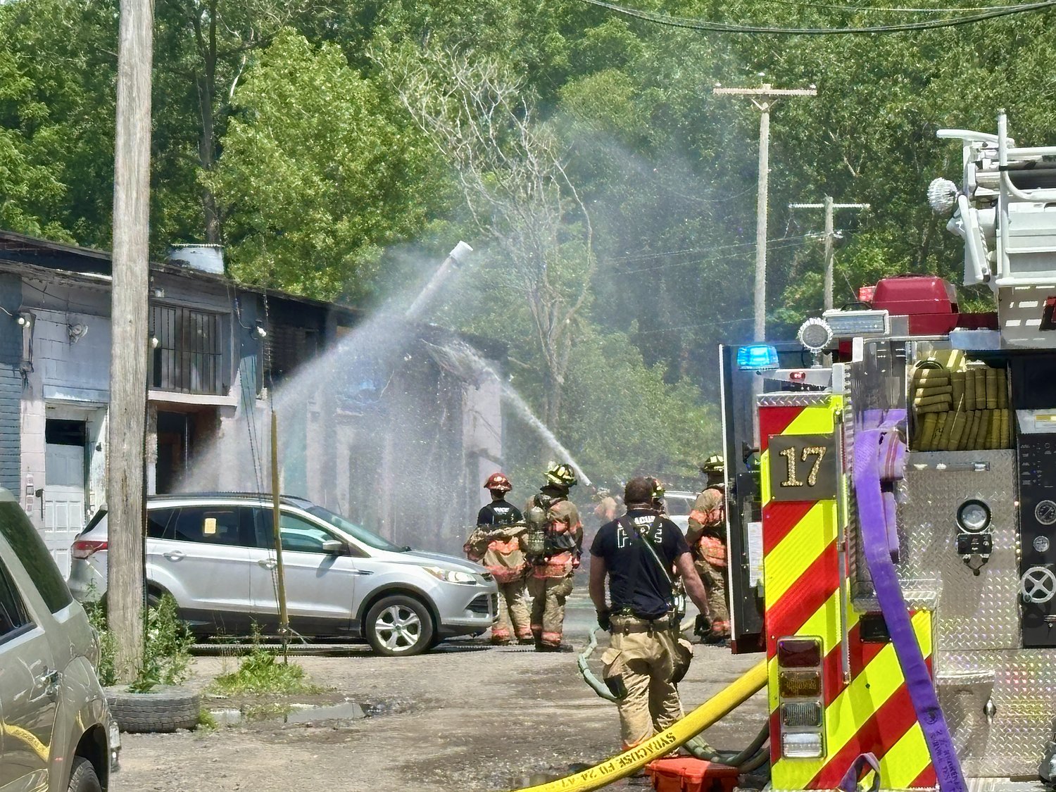 Syracuse firefighters battle auto shop fire in 90-degree heat